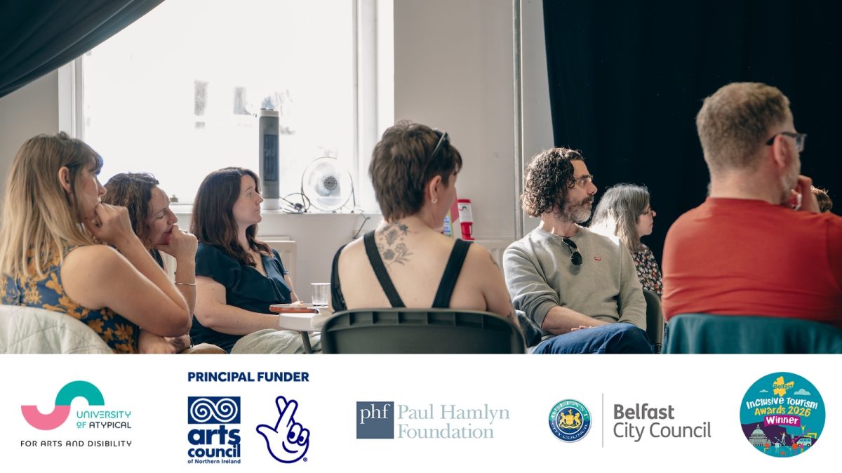 Photograph of a group of people sitting on chairs in a white-walled room. One has her back to the camera, others are sitting at ninety degrees to the camera. All are looking in the same direction. Below are 5 logos: University of Atypical, Arts Council of Northern Ireland, Paul Hamlyn Foundation, Belfast City Council, Embrace the Inclusive Spirit.